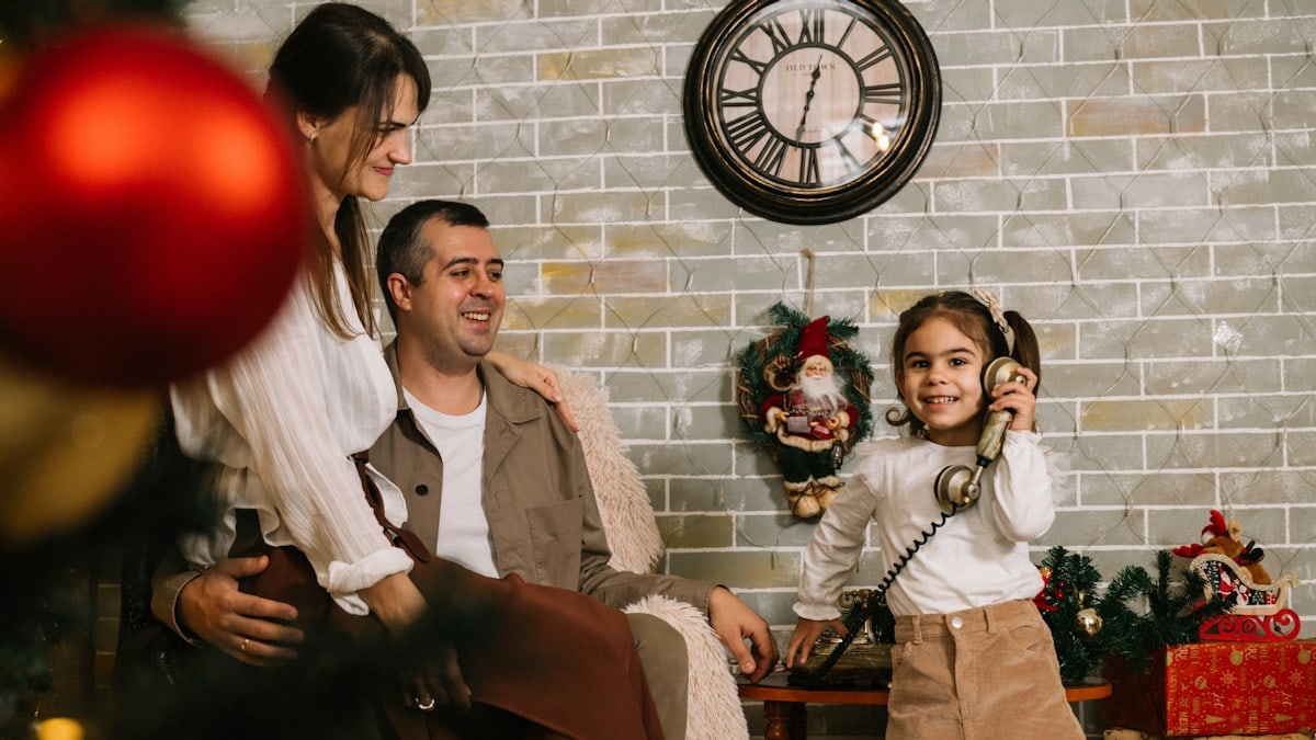 A group of people sitting around a christmas tree
